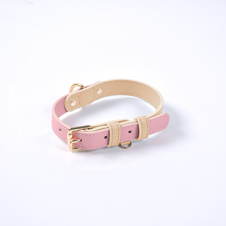 Collier en cuir rose avec bord beige, boucle dorée et anneau d’attache.