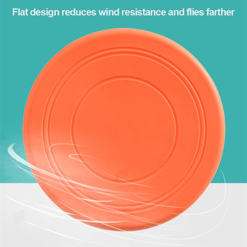 Disque frisbee flottant orange pour chien, surface nervurée et rebords.