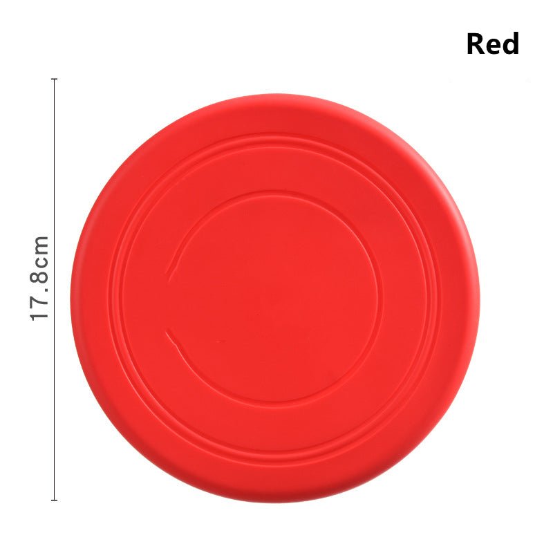 Disque frisbee flottant rouge pour chien, rond et nervuré.