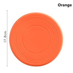 Disque frisbee flottant orange pour chien, rond avec lignes concentriques.