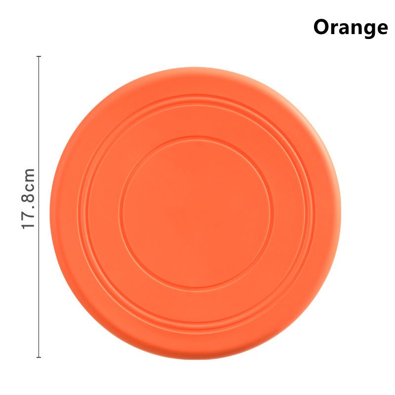 Disque frisbee flottant orange pour chien, rond avec lignes concentriques.