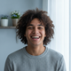 A happy young adult smiling, representing a satisfied customer.